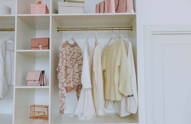  Female clothes and accessories nicely organized in a wardrobe as a good example how to properly highlight storage space when staging your home