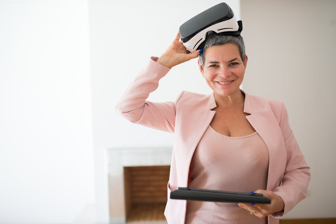 Woman holding tablet and VR glasses